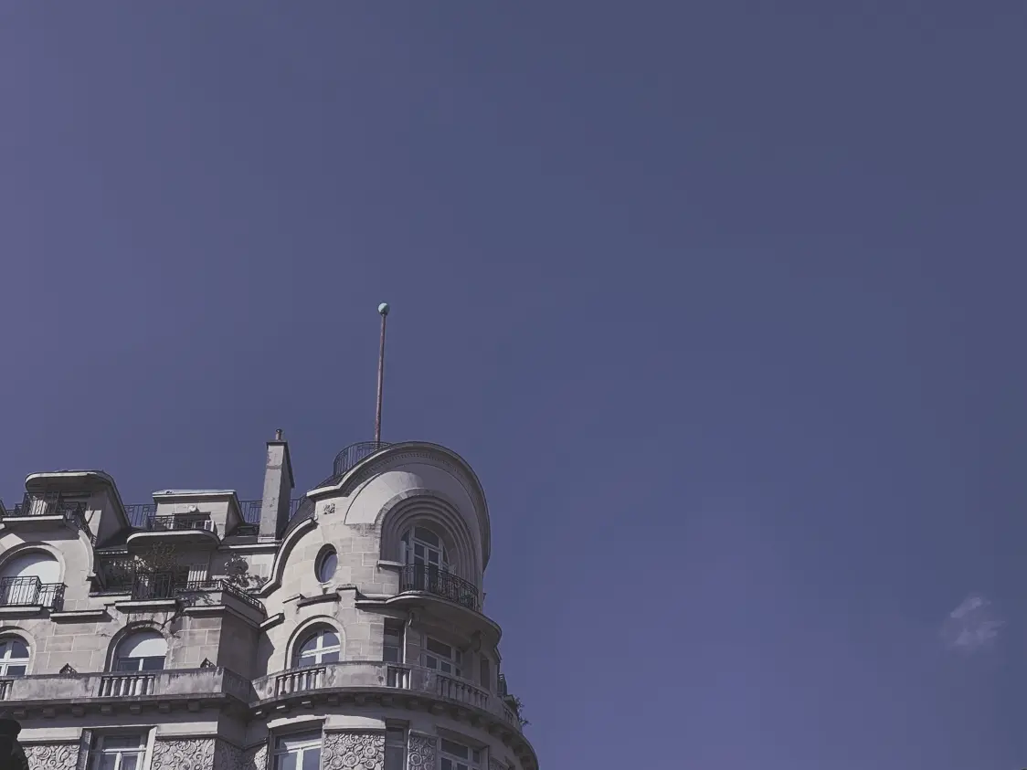 a tall building with a flag on top of it